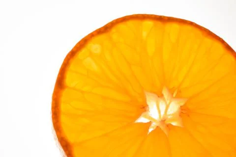 Luminous mandarin slice on white background Stockfoto's