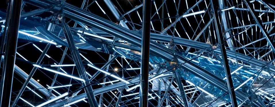 Luminous metal construction of randomly intersecting lines. Stock Photos