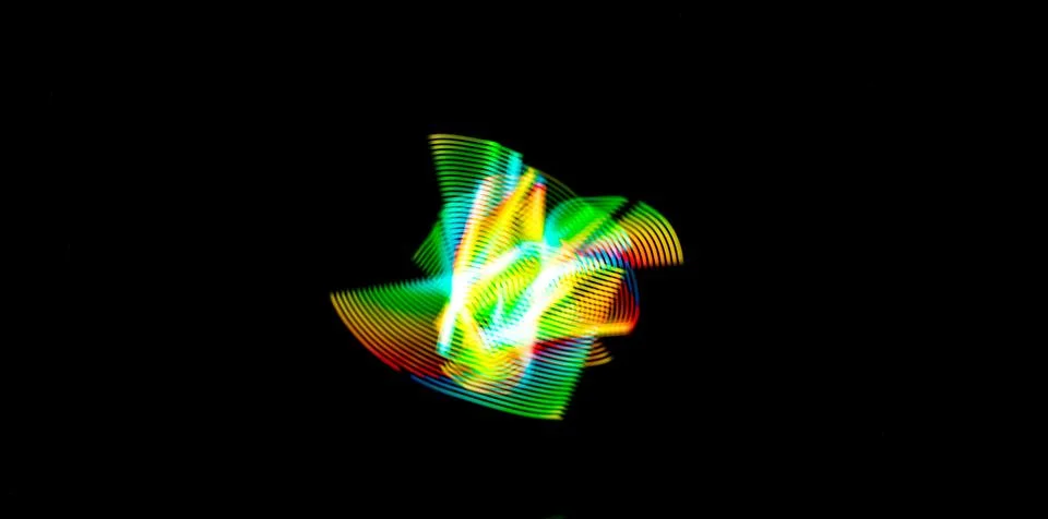 Luminous multicolored abstraction in motion on a black background Stock Illustration