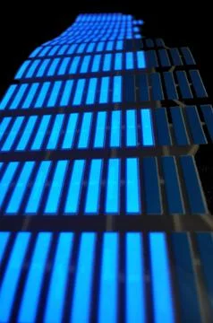 Luminous panel of pixels, with neon blue with green color and an equalizer 写真素材