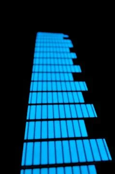 Luminous panel of pixels, with neon blue with green color and an equalizer Stock Photos