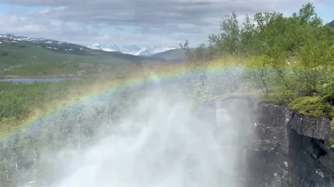 Luminous rainbow extends across peaceful river scene. Colorful rainbow arches Stock Footage 327916829