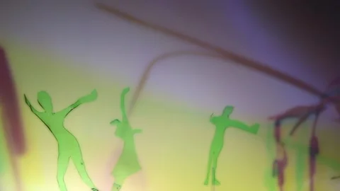 Luminous Shadows: Plastic People Moving Through Light Stock Footage 302412460