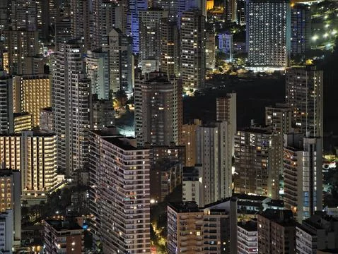 Luminous skyline with diverse architecture reflected in tranquil waters during Stock Photos