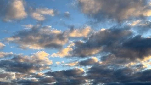 Luminous sunset clouds in a vibrant sky reflecting warmth and tranquility o.. Stock Photos