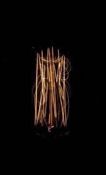 Luminous thread of a retro Edison lamp on a dark background Stock Photos