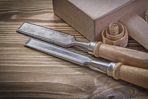 Lump hammer chisel curled scobs on vintage wooden board building concept Stock Photos