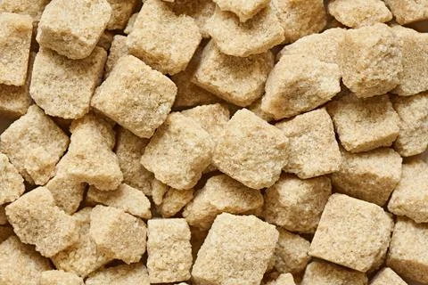 Lumpy brown sugar close-up, background, shallow depth of field Stock Photos