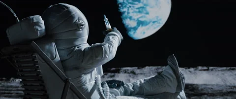 Lunar astronaut having a beer while resting in a beach chair on Moon surface Stock Footage 156029881