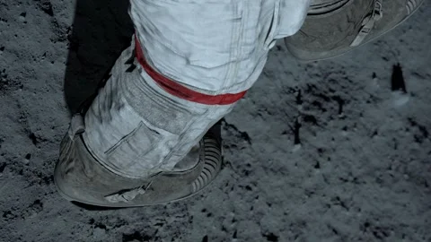 Lunar astronaut walking on the moon's surface and leaves a footprint Stock Footage 245611534