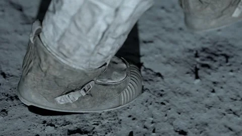 Lunar astronaut walking on the moon's surface and leaves a footprint in the Stock Footage 245722410