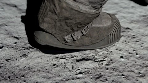Lunar astronaut walking on the moon's surface and leaves a footprint in the Stock Footage 247789436