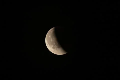 Lunar eclipse beginning close-up from the right corner, the sun begins to com Stock Photos