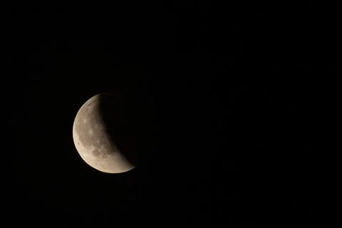 Lunar eclipse beginning close-up right corner sun begins to come on top of .. Stock Photos
