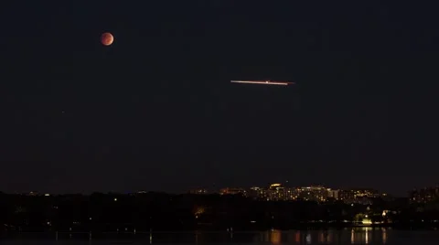 Lunar eclipse blood moon approaching horizon as dawn breaks timelapse Stock Footage 43266942