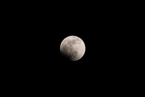 Lunar eclipse full crescent super moon rising against the dark sky Fotos Stock