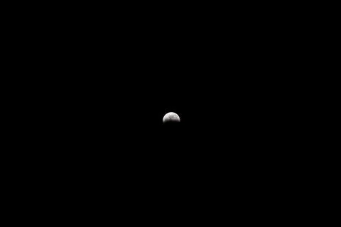 Lunar Eclipse Moon Isolated Against Deep Black Night Sky Stock Photos