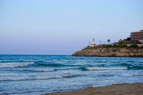 Lunar eclipse over the lighthouse of cullera Stock Photos