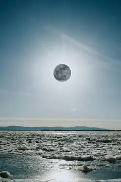 Lunar Eclipse over a river in winter in Russia Stock Photos