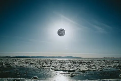 Lunar Eclipse over a river in winter in Russia Stock Photos