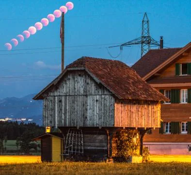 Lunar eclipse trail red moon in rural place lucerne Stock Photos