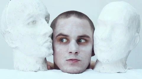 Lunatic between two heads made of plaster Stock Footage 67599907