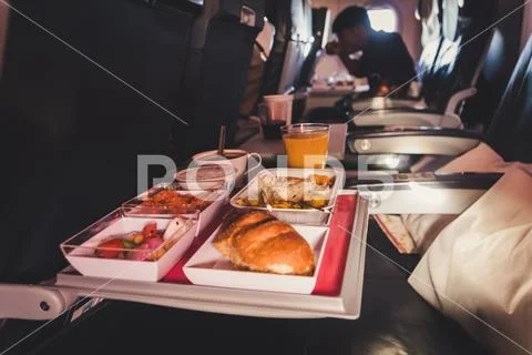 Lunch in airplane. Inflight economy class meal on tray Stock Photos