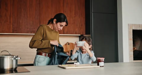 Lunch, backpack and mom with child in kitchen to prepare for school, academy and Stock Footage 335536567