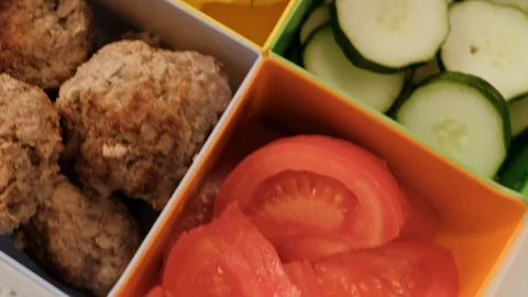 Lunch box with cells. vegetables, cucumbers and tomatoes, boiled potatoes and Stock Footage 113034975