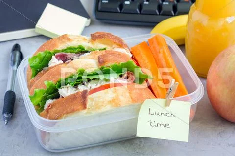 Lunch box with chicken salad sandwiches and carrot sticks, horizontal Stock Photos