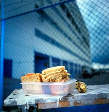 Lunch box containing cold cut sandwiches, banana Foto stock