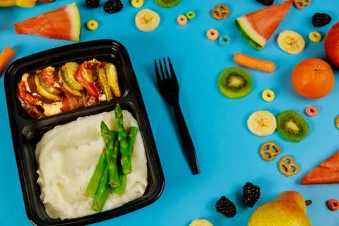 Lunch boxes with mashed potato and vegetables ready for work or school. Stock Photos