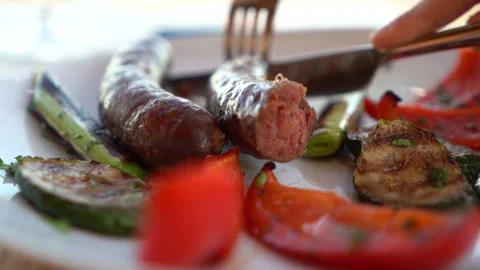 Lunch in a fancy restaurant. Close-up of a plate of sausage dish with grille Stock Footage 265171884