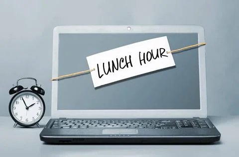 Lunch hour laptop with note about lunch hour Copyright: xZoonar.com/Sergey... Stock Photos