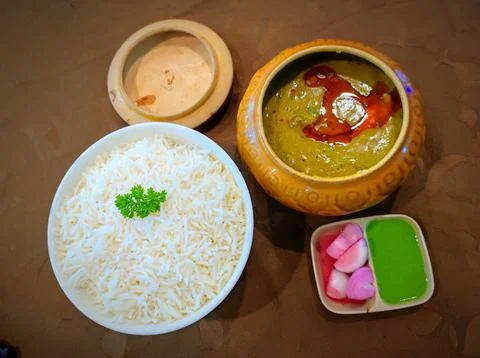 Lunch includes rice, curry, and sides served on a table at a local restaura.. Stock Photos