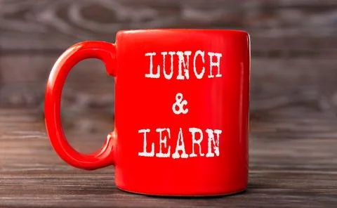 LUNCH &amp; LEARN - word on a red cup on a dark background. Stock Photos