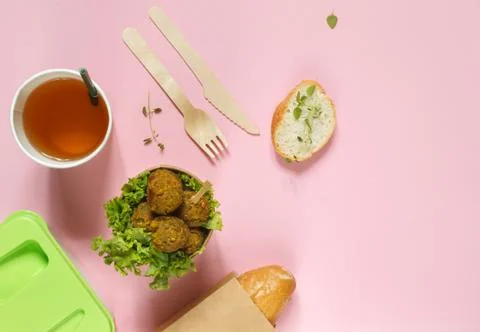 Lunch with a portion of falafel, bread and a drink. Layout on a pink background Stock Photos