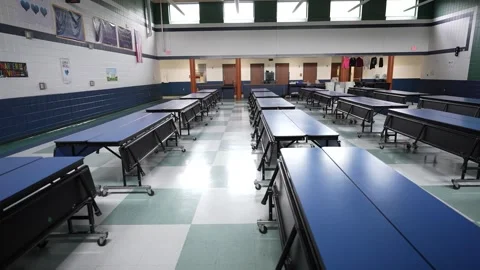 Lunch Setup in Junior High Cafeteria With Tables Arranged for Midday Meal Stock Footage 309682545