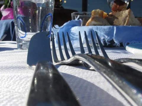 Lunch table setting outdoors in white blue colors . Forks and knife Stock Photos