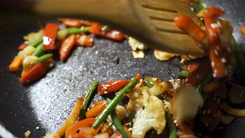 Lunch of vegetables. Cook the vegetable stew in a pan. Frozen vegetables on a Stock Footage 151742140