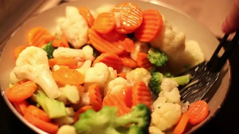 Lunch of vegetables. Cook the vegetable stew in a pan. Frozen vegetables on a Stock Footage 226859554