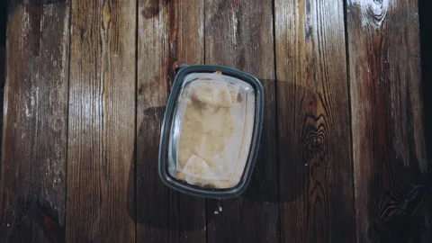 The lunchbox with cheburek rotates on the table Stock Footage 151591659