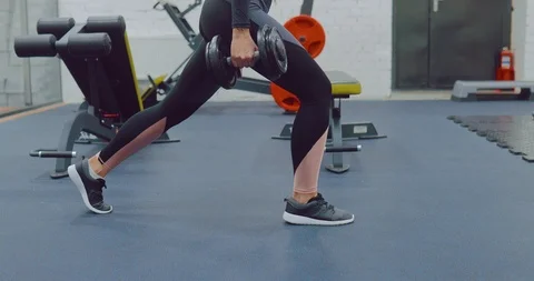 Lunging legs with dumbbells, basic exercise. Training the muscles of the legs Stock Footage 122705676