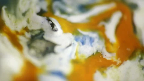 Luqiud vivid orange color mixing together on white background. Painting, spla Stock Footage 147745864