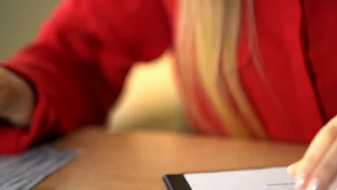 Luscious blonde in a red jacket performs office work, an office girl with big Stock Footage 100371799