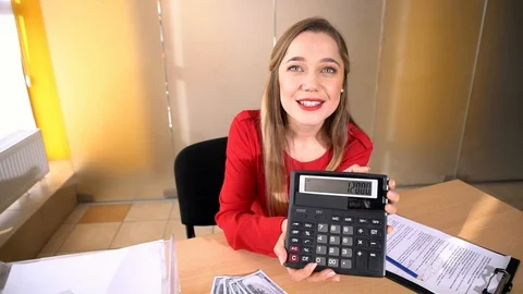Luscious blonde in a red jacket performs office work, an office girl with big Stock Footage 100371856