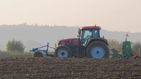 Lush and loosen the soil on the field before sowing. The tractor on field Stock Footage 112082453