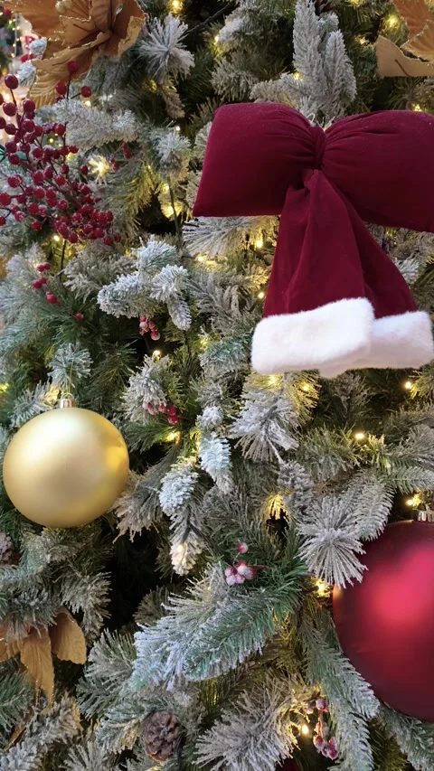 A lush Christmas tree adorned with red velvet bows 動画素材 323201614