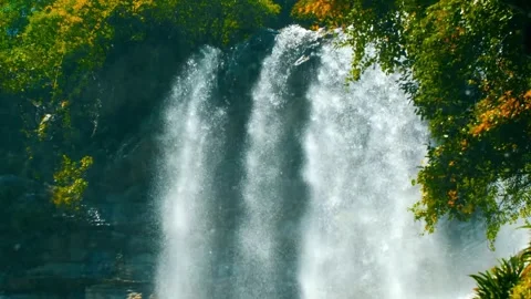 Lush Foliage Frames a Cascading Waterfall's Misty Spray Stock Footage 301087756