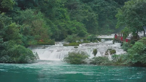 Lush Forest Waterfall Cascading Over Rocks in Tropical Scenic Area Video stock 333041616